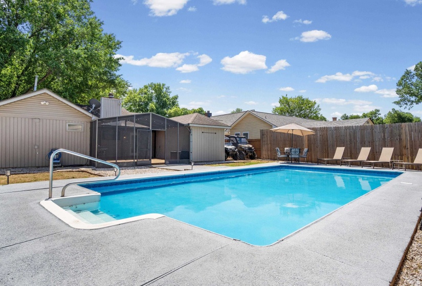 In-ground swimming pool with concrete surround