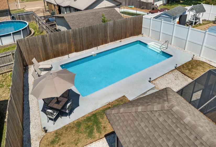 Rectangular in-ground swimming pool with steps and handrails