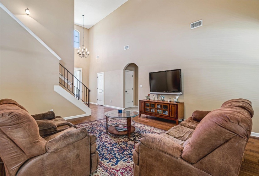 Vaulted Great Room featuring wood flooring, and multiple windows