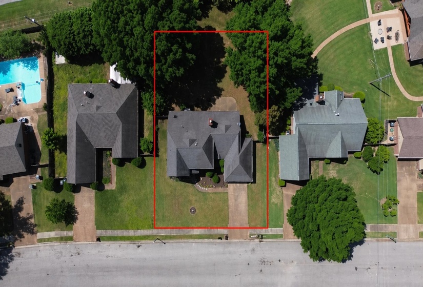 Two-story residence featuring a dark shingle roof and a green lawn