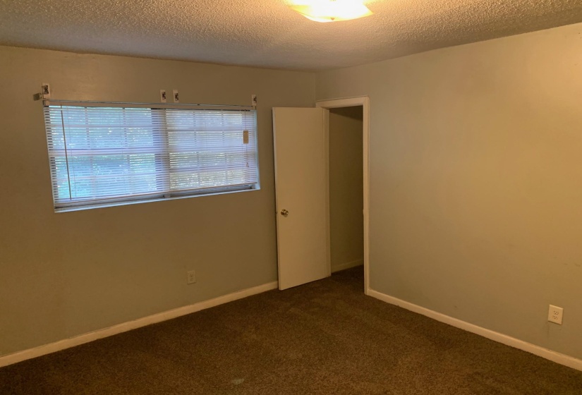 Unfurnished room with a textured ceiling and carpet