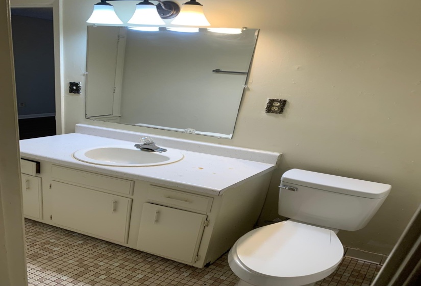 Half bathroom featuring light tile patterned flooring and vanity