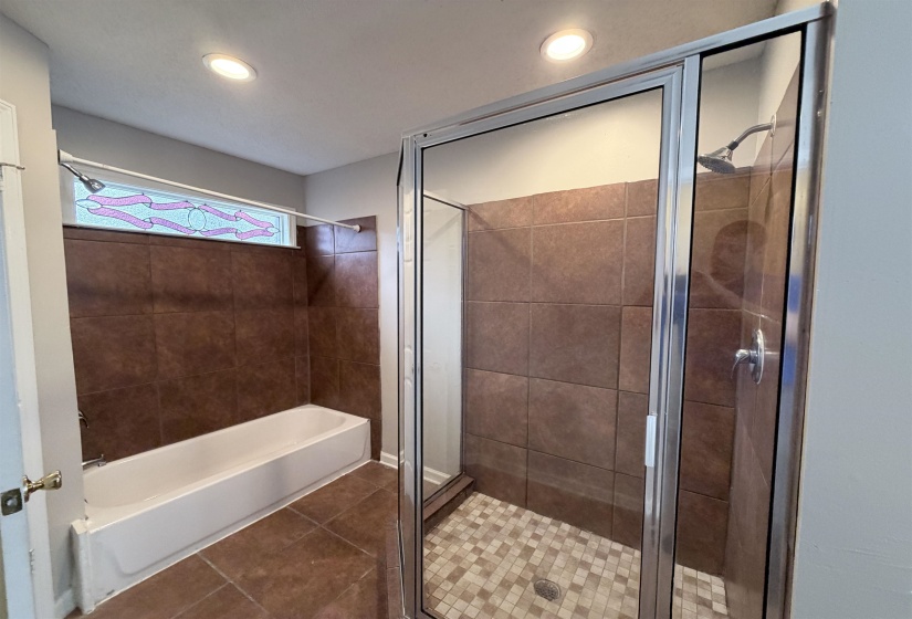 Full bathroom featuring a shower stall, tile patterned flooring, a bathtub, and recessed lighting