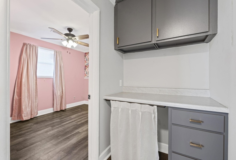 Kitchen with gray cabinets, light countertops, dark wood-type flooring, and ceiling fan