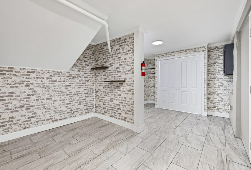 Unfurnished bedroom with a closet and crown molding