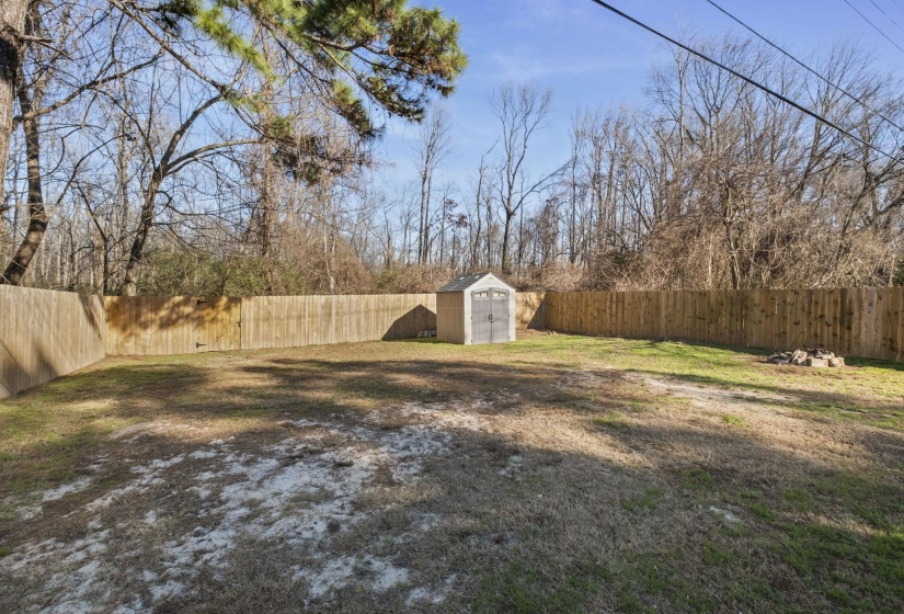 Fenced backyard with a storage unit