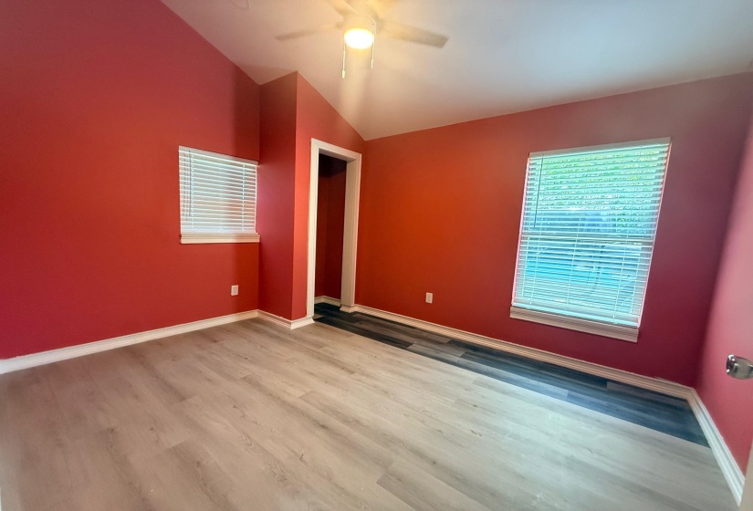 Spacious interior featuring vaulted ceilings and light wood-finish flooring