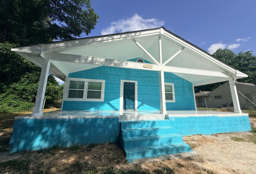 Vibrant turquoise siding exterior with a contrasting white trim