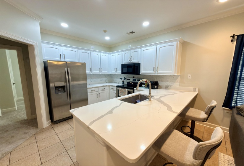 The kitchen has been completely renovated, new countertops, backsplash and appliances.