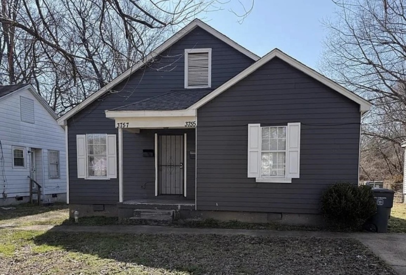 Dark-toned siding exterior with white window shutters