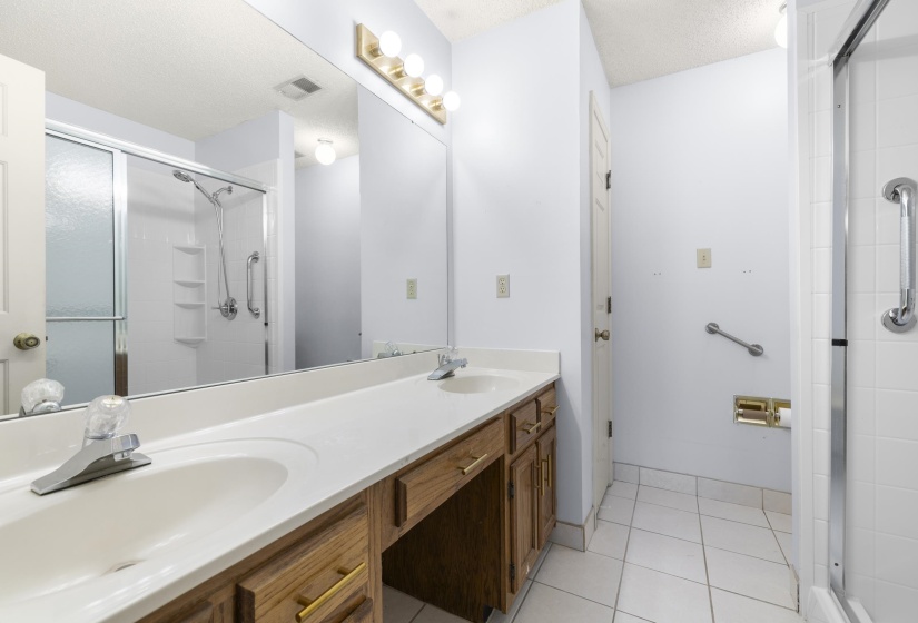 Double vanity with integrated sinks and wood-finish cabinetry