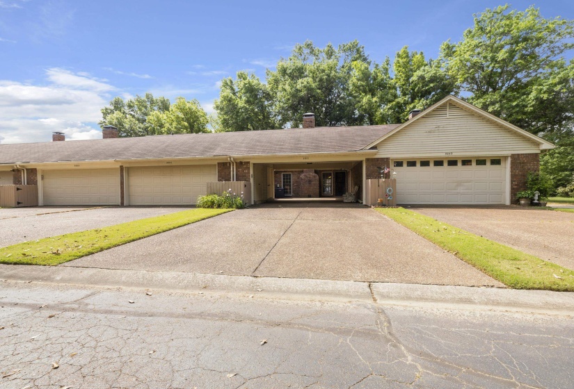 Expansive concrete driveway servicing multiple attached properties