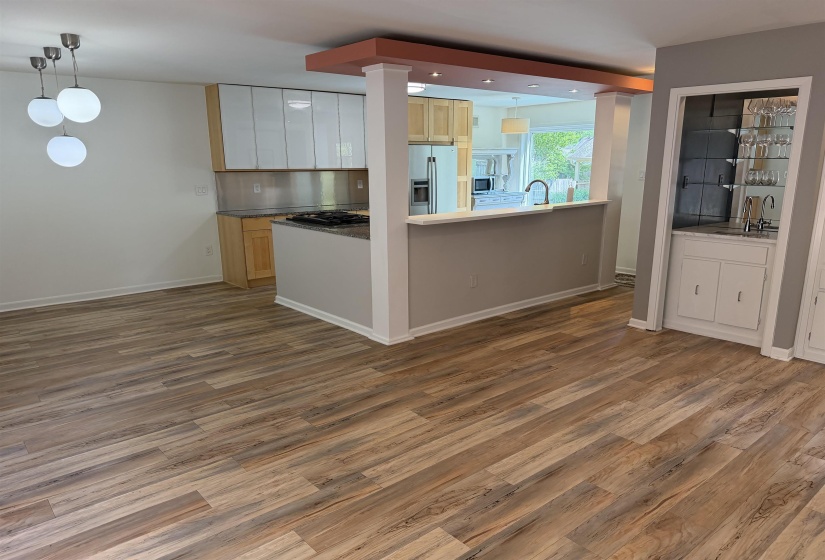 Open-concept living area with wood-finish flooring