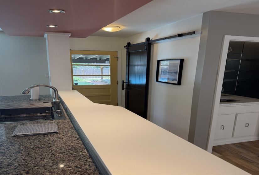 Kitchen counter featuring a stainless steel faucet with a double basin sink set into granite countertops