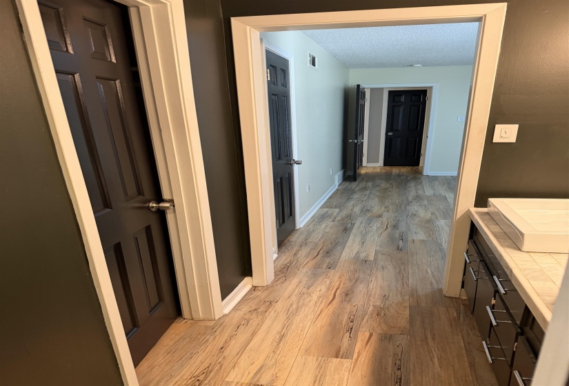 Wood-finish flooring throughout the hallway