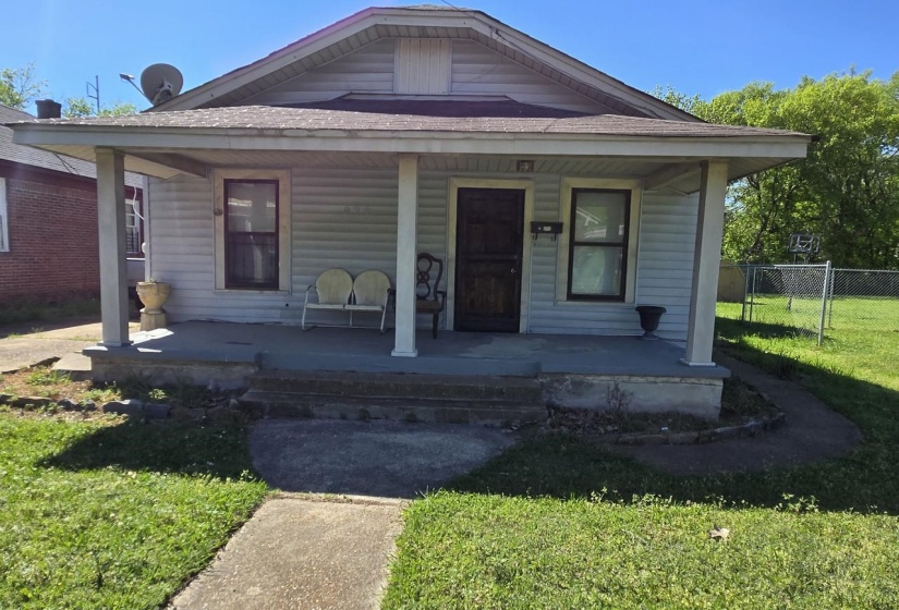 Exterior featuring a covered front porch with columnar supports, horizontal siding, and a dark entry door