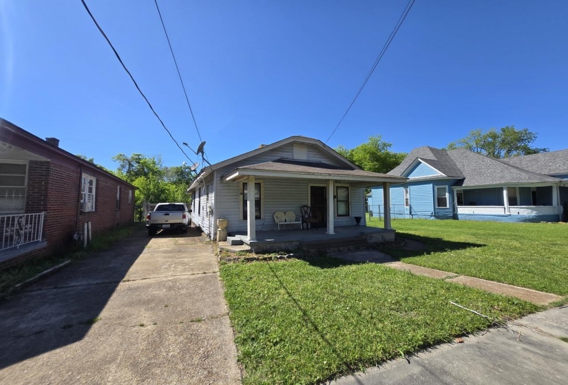 Single-story residence featuring light-colored siding and a covered front porch