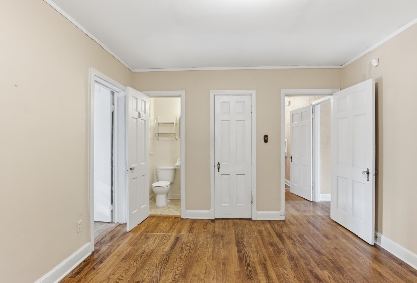 Wood-finish flooring throughout, featuring light beige walls and white trim
