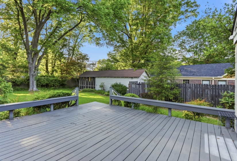 Expansive wooden deck featuring painted gray planks and matching railings