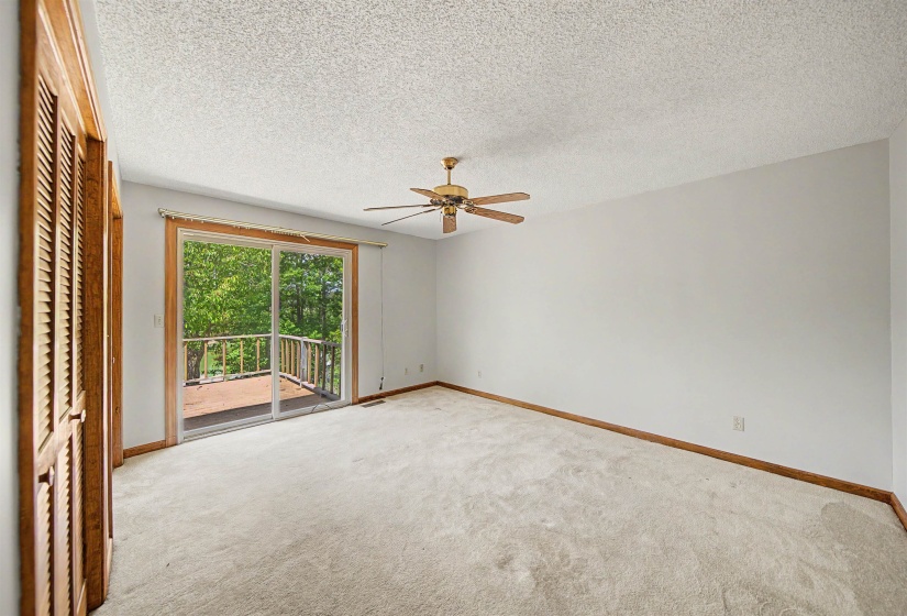 Room with sliding glass door opening to an outdoor deck