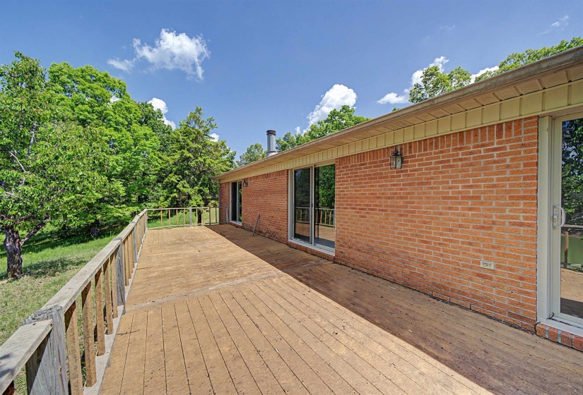 Spacious wood deck with a natural finish, featuring a wood railing