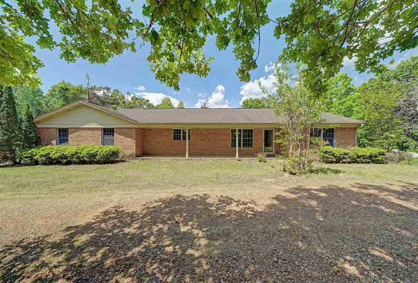 Brick exterior with a gabled roofline and covered porch entry