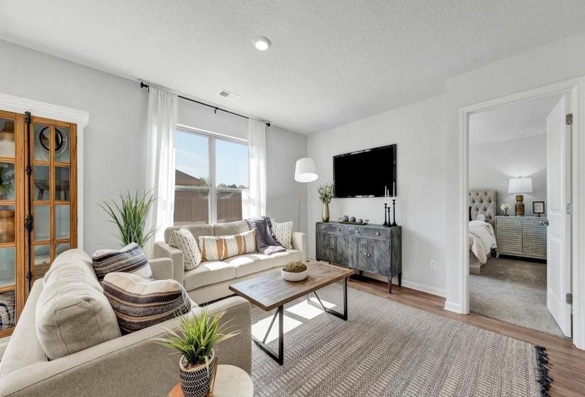 Living room featuring a textured ceiling and wood finished floors