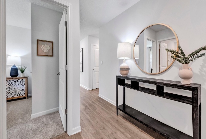 Hallway with baseboards and light wood finished floors