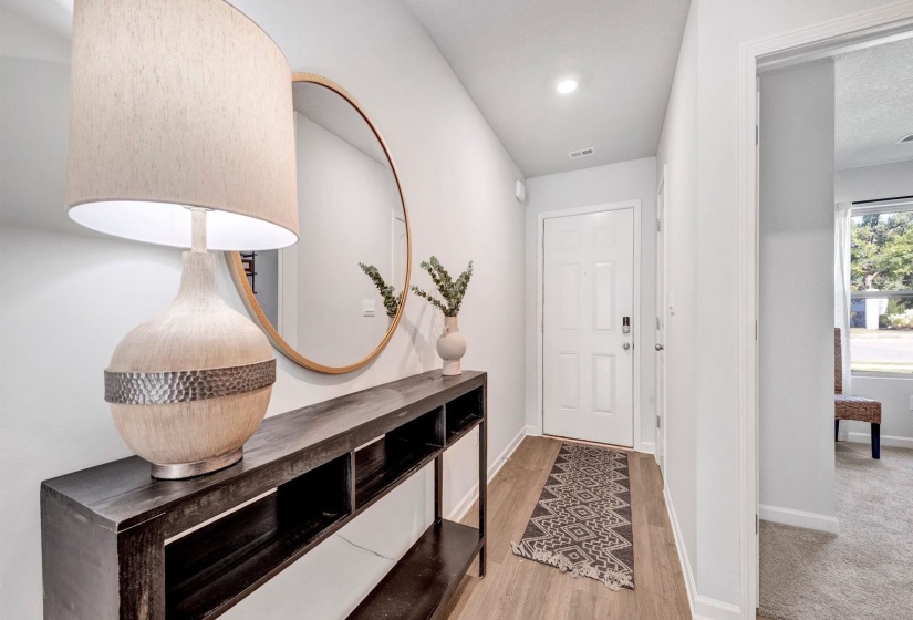 Foyer with baseboards and light wood-style flooring