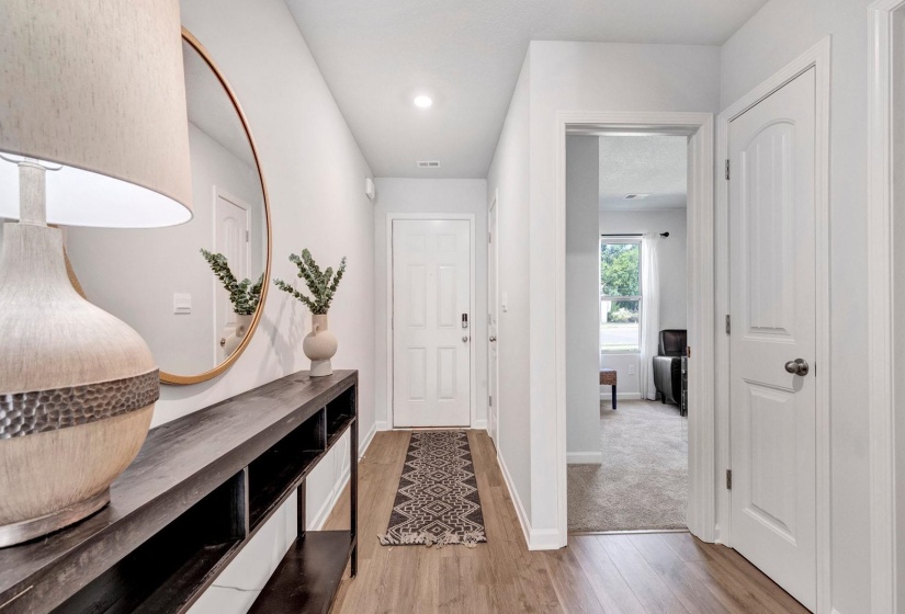 Entryway with light wood-style flooring and recessed lighting