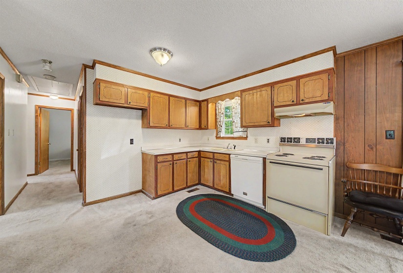 Kitchen featuring wood cabinetry, white countertops, and a white electric range