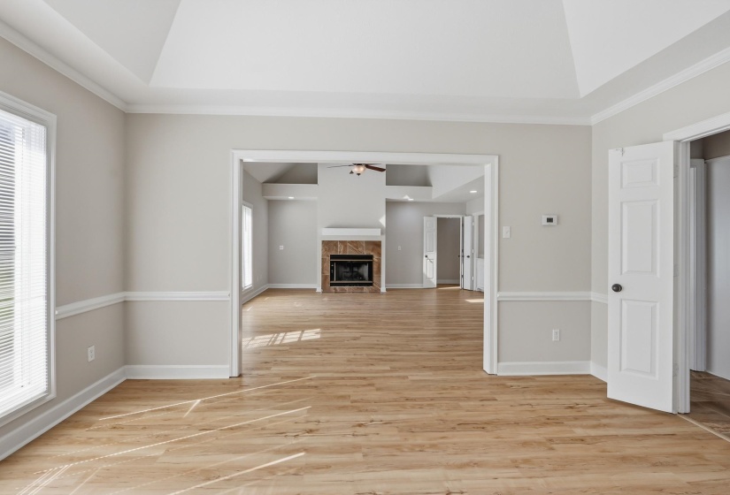 Interior room featuring wood-finish flooring, two-tone painted walls, and a tray ceiling