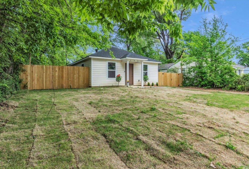 Classic white siding exterior with a dark shingle roof