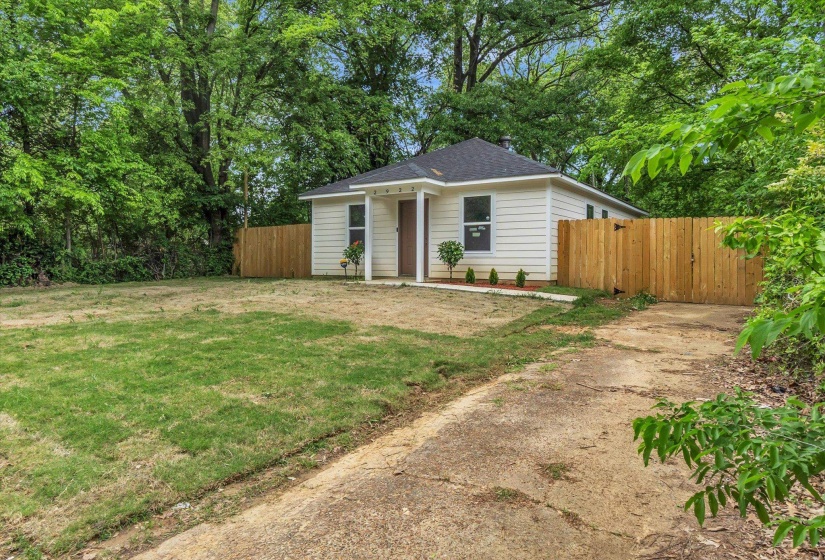 Single-story residence featuring white siding and a dark shingle roof