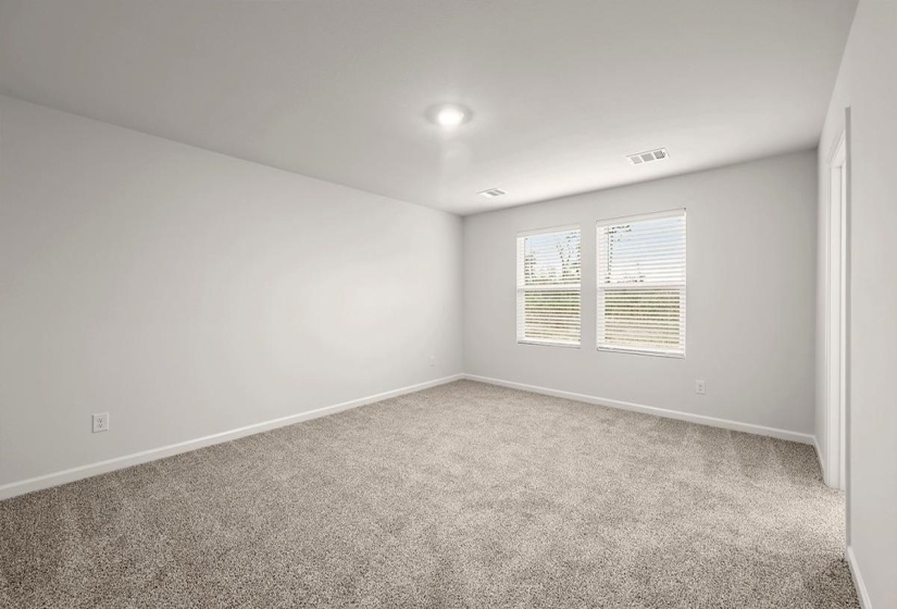 Spare room featuring carpet flooring and baseboards