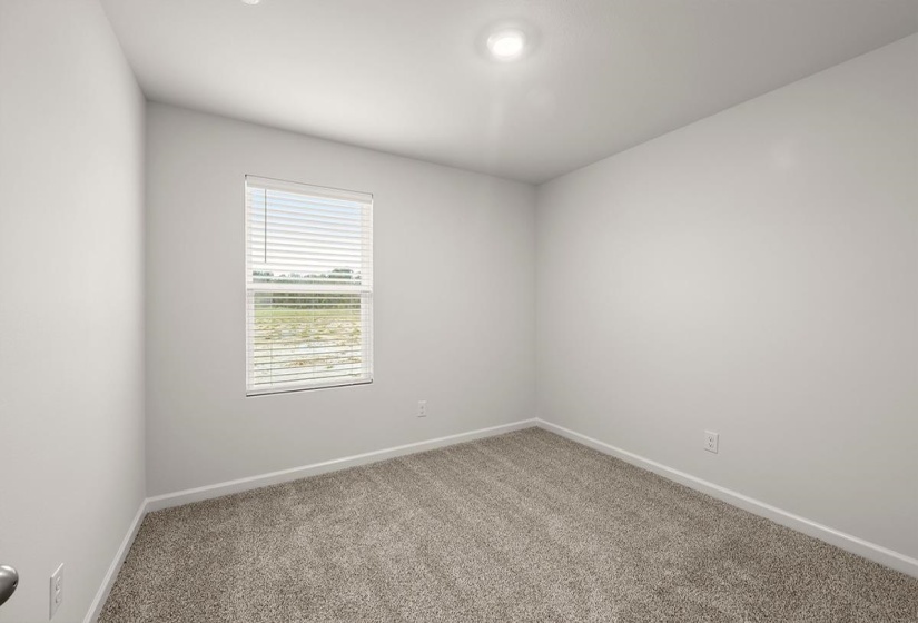 Empty room featuring baseboards and light carpet