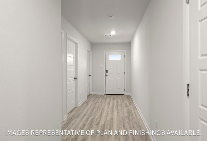 Doorway to outside featuring wood finished floors and baseboards