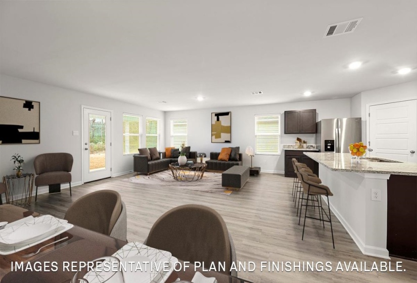 Living area with light wood finished floors, plenty of natural light, and recessed lighting