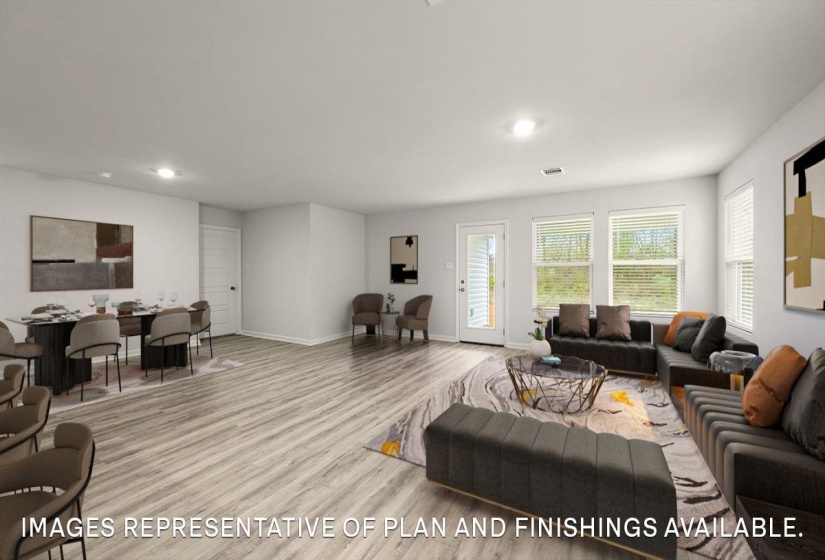 Living area with light wood-type flooring and recessed lighting