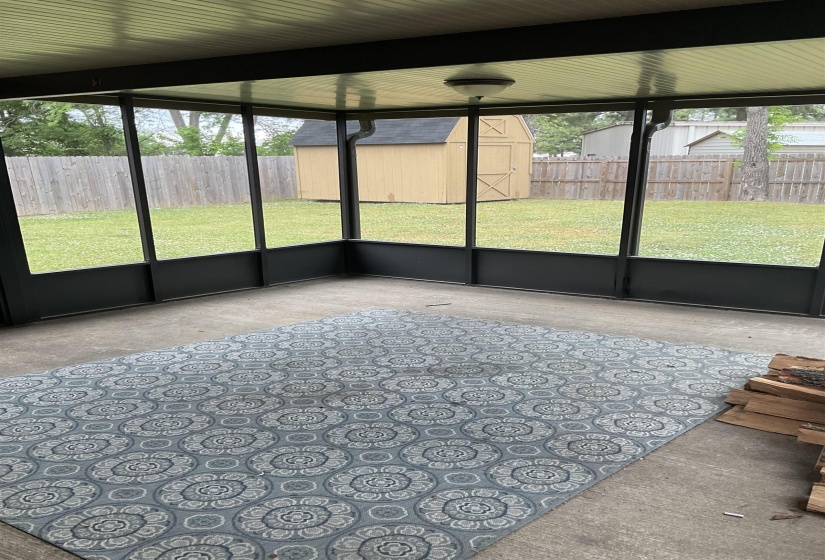 Screened patio with concrete flooring, recessed lighting, and a paneled ceiling