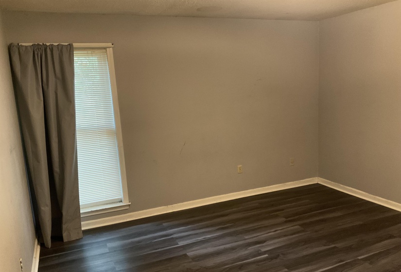 Room featuring light gray walls and dark wood-finish flooring