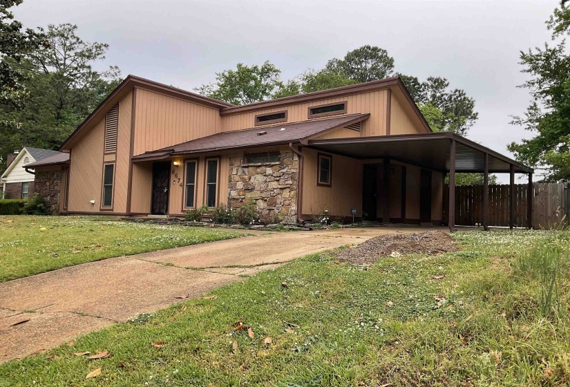 Front exterior with stone facade accents and tan siding