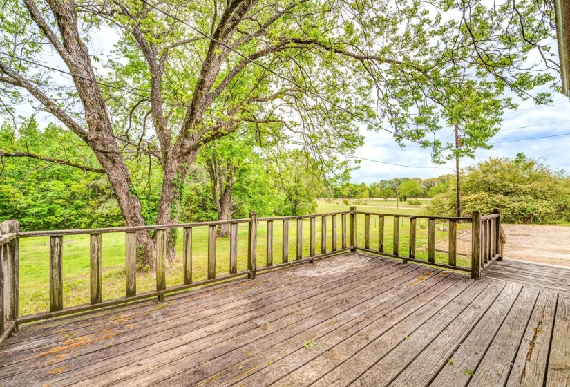 Expansive wooden deck with a natural wood railing