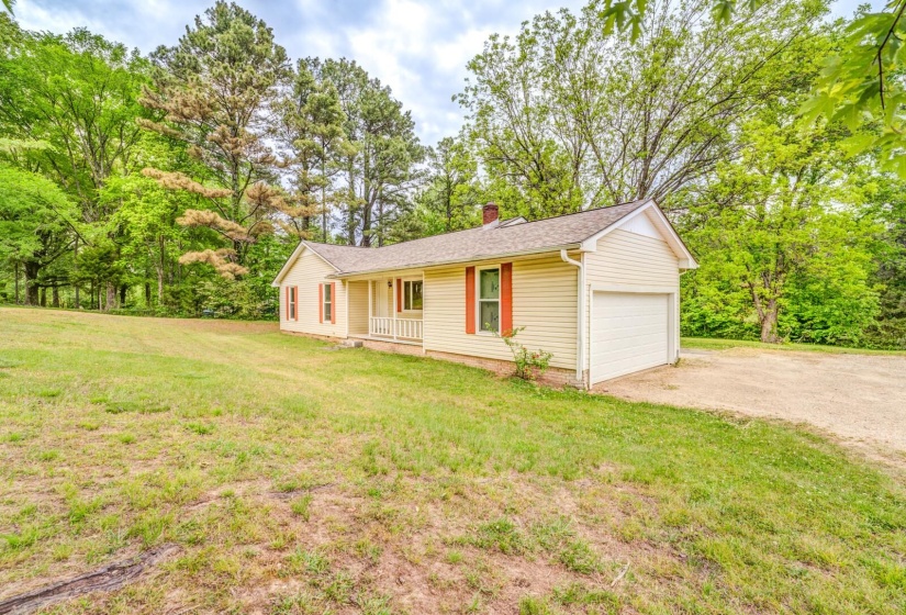 Single-story residence featuring light-colored siding and a covered front porch with white railing