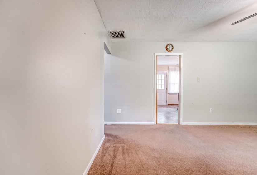 Interior room featuring light-colored walls and brown carpeting