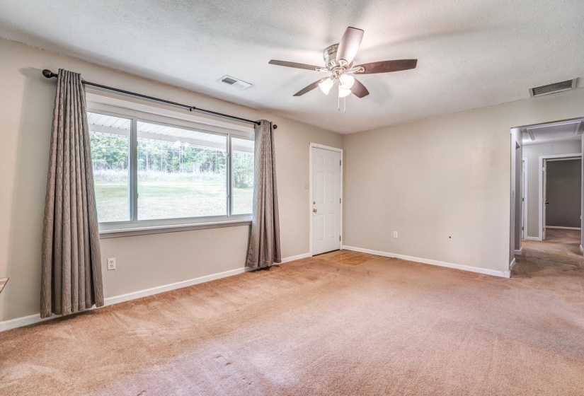 Living space with neutral-toned carpet and light gray walls