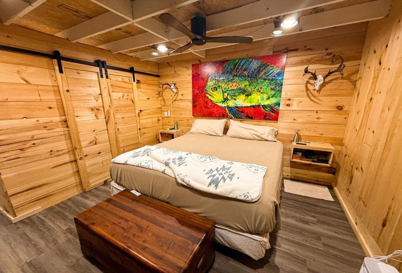Room featuring wood-plank walls and a wood-finish flooring