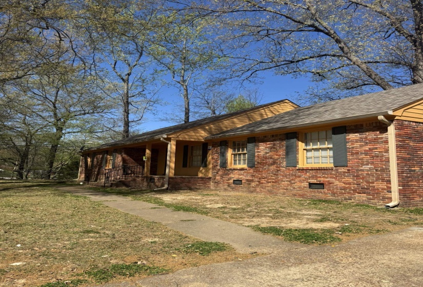 Brick exterior with shingle roofing and wood-finish gables