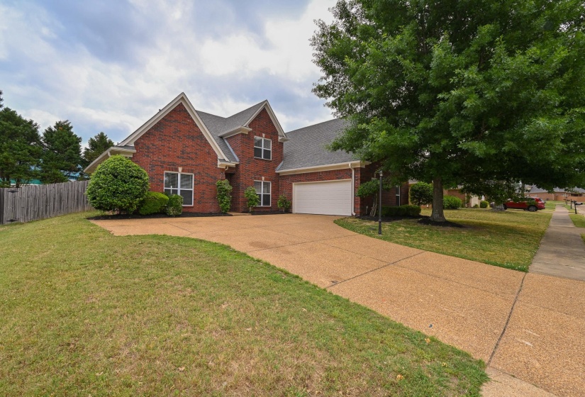Brick exterior featuring a two-story design and attached garage