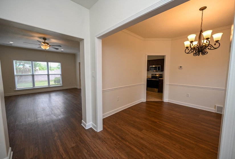 Open-concept living space featuring wood-finish flooring throughout